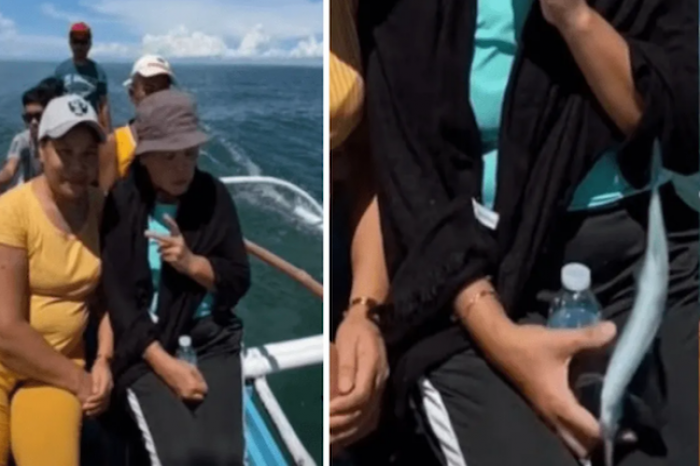 Posaba para una foto en medio del mar, pero un pez volador se roba su celular